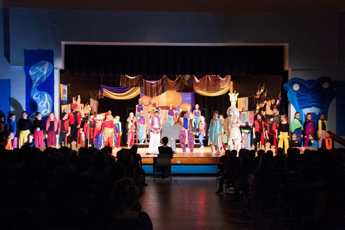 Final scene of cast on stage in Aladdin.