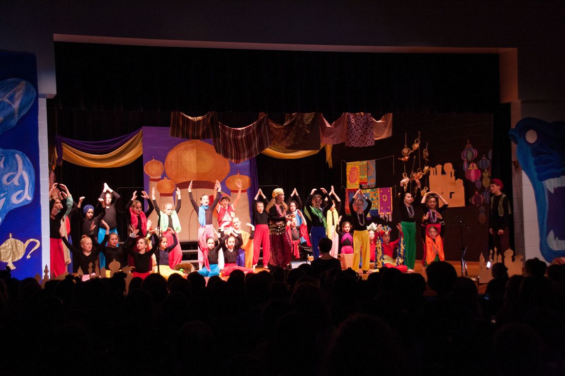 Entire cast of Aladdin performers at end of musical on stage.Picture